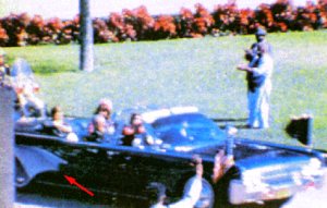Frame 228 of the Zapruder film. Arrow points to opened umbrella.