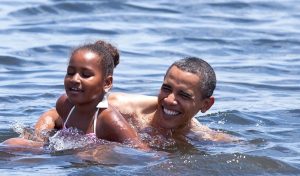 President Barack Obama and daughter Sasha swim at Panama City Beach, Florida, August 2010, as part of a campaign to encourage Americans to travel to Gulf Coast beaches. White House Photo 