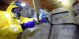 Handlers gather samples of waste for analysis. Photo credit: Department of Energy