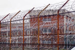 Razor wire fence surrounding inmate housing at Riker’s Island.
