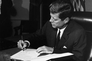 President Kennedy signed the Proclamation for Interdiction of the Delivery of Offensive Weapons to Cuba on October 23, 1962. The night before, on October 22, he delivered an address to the nation via television on "Soviet military buildup on the island of Cuba."  Photo Credit: Photograph by Cecil Stoughton, White House, in the John F. Kennedy Presidential Library and Museum, Boston.