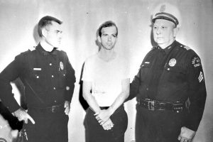 Lee Harvey Oswald and two policemen taken after Oswald's arrest. Photo credit: ARCHIVES.GOV.