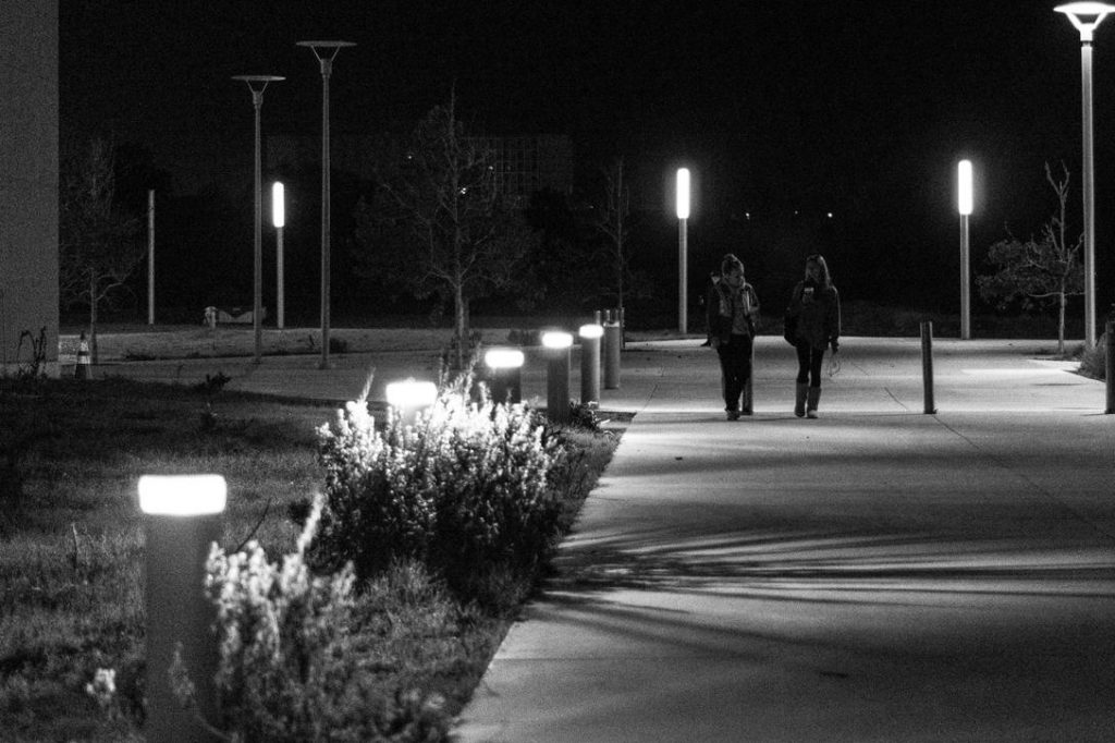 Women on campus at night.