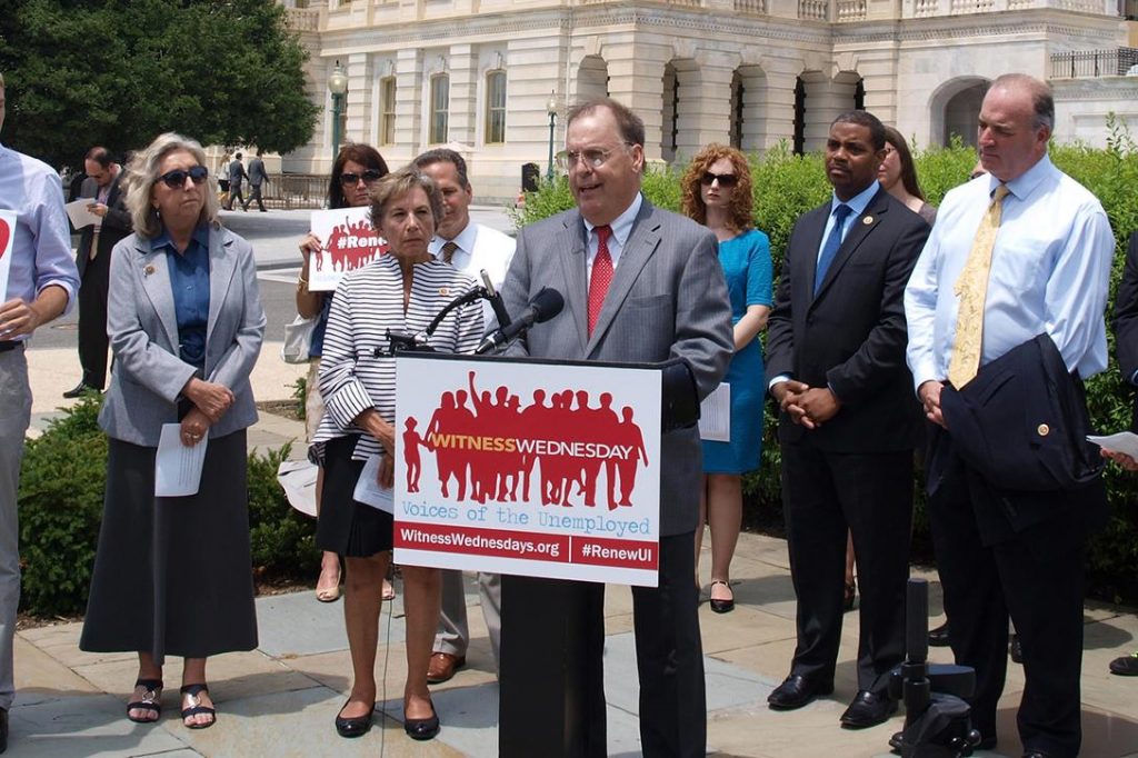 John Fugazzie of Neighbors-helping-Neighbors reads a story from an American calling on Congress for help as the long-term unemployed continue to search for work, July 16, 2014. Photo credit: Center for Effective Government / Flickr (CC BY-NC 2.0) 