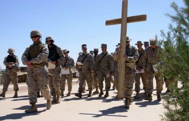 Soldiers carrying cross