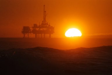 Sunset over oil rig off Huntington Beach, California