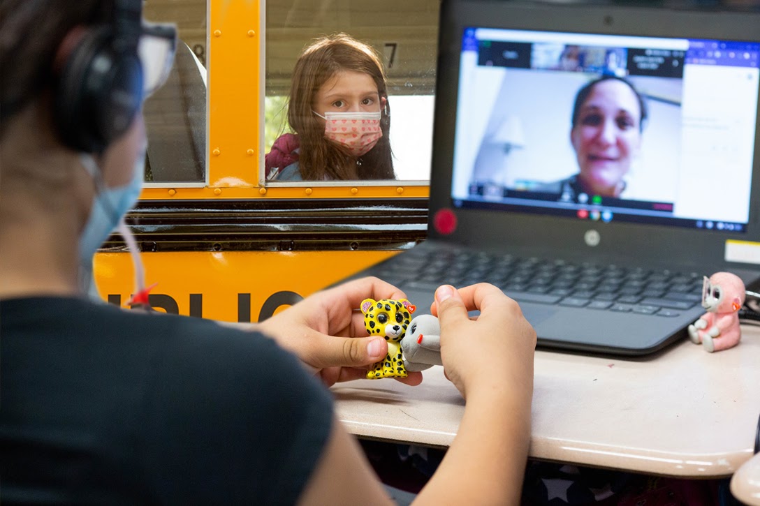 Girl, school bus, COVID-19, remote learning