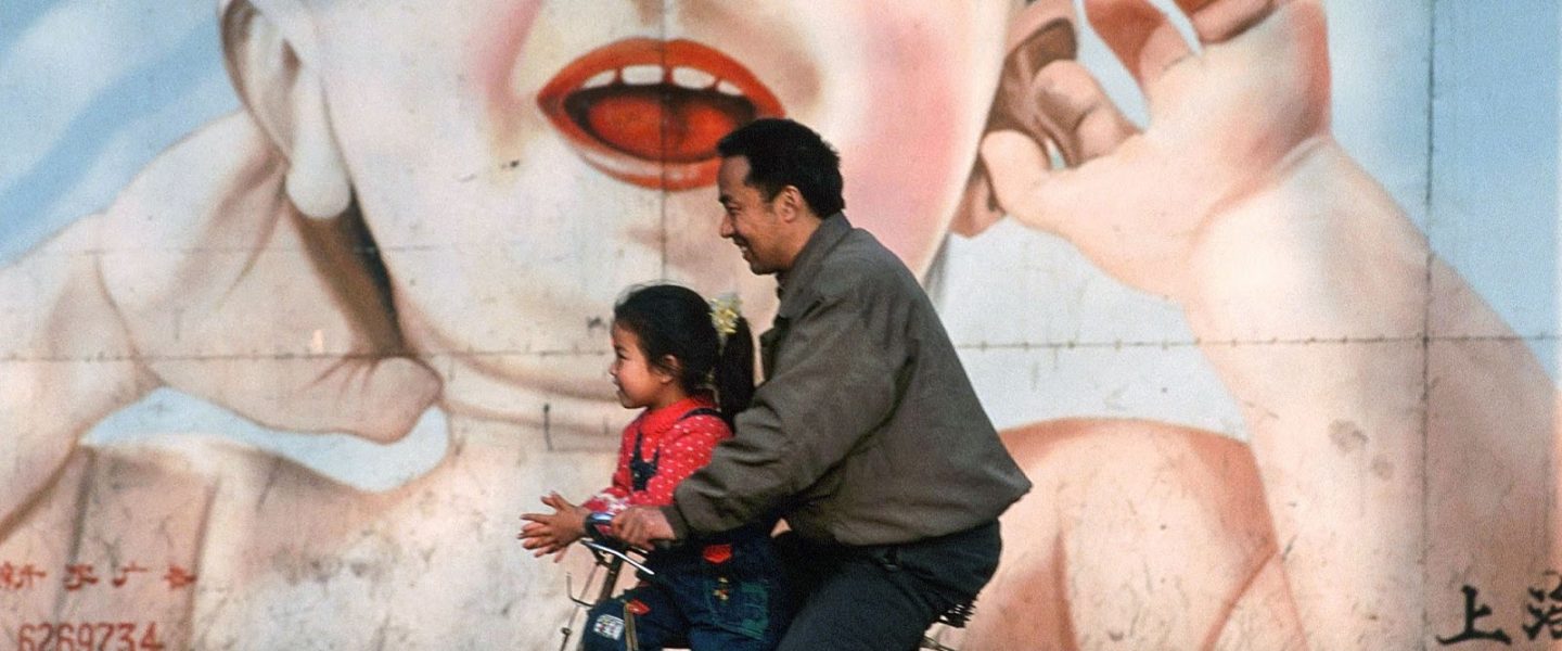Chinese man, child, billboard