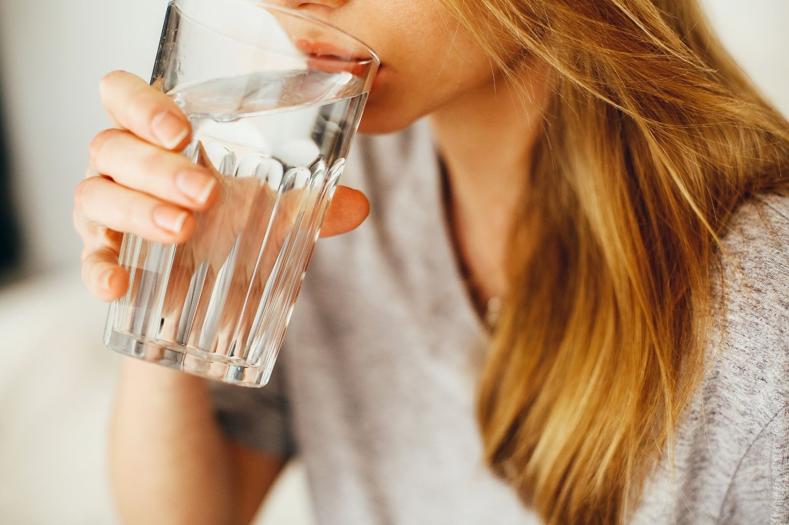 woman drinking water glass