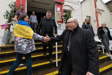 Catholic priest, welcomes, Ukrainian refugee
