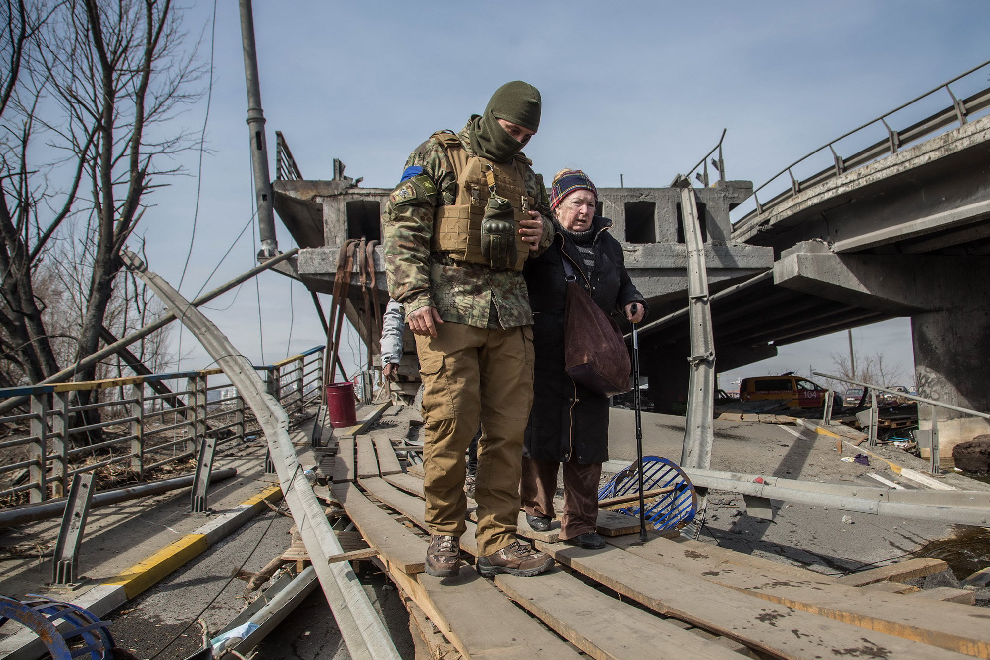 Ukraine, displaced, older woman, Soldier wrecked bridge