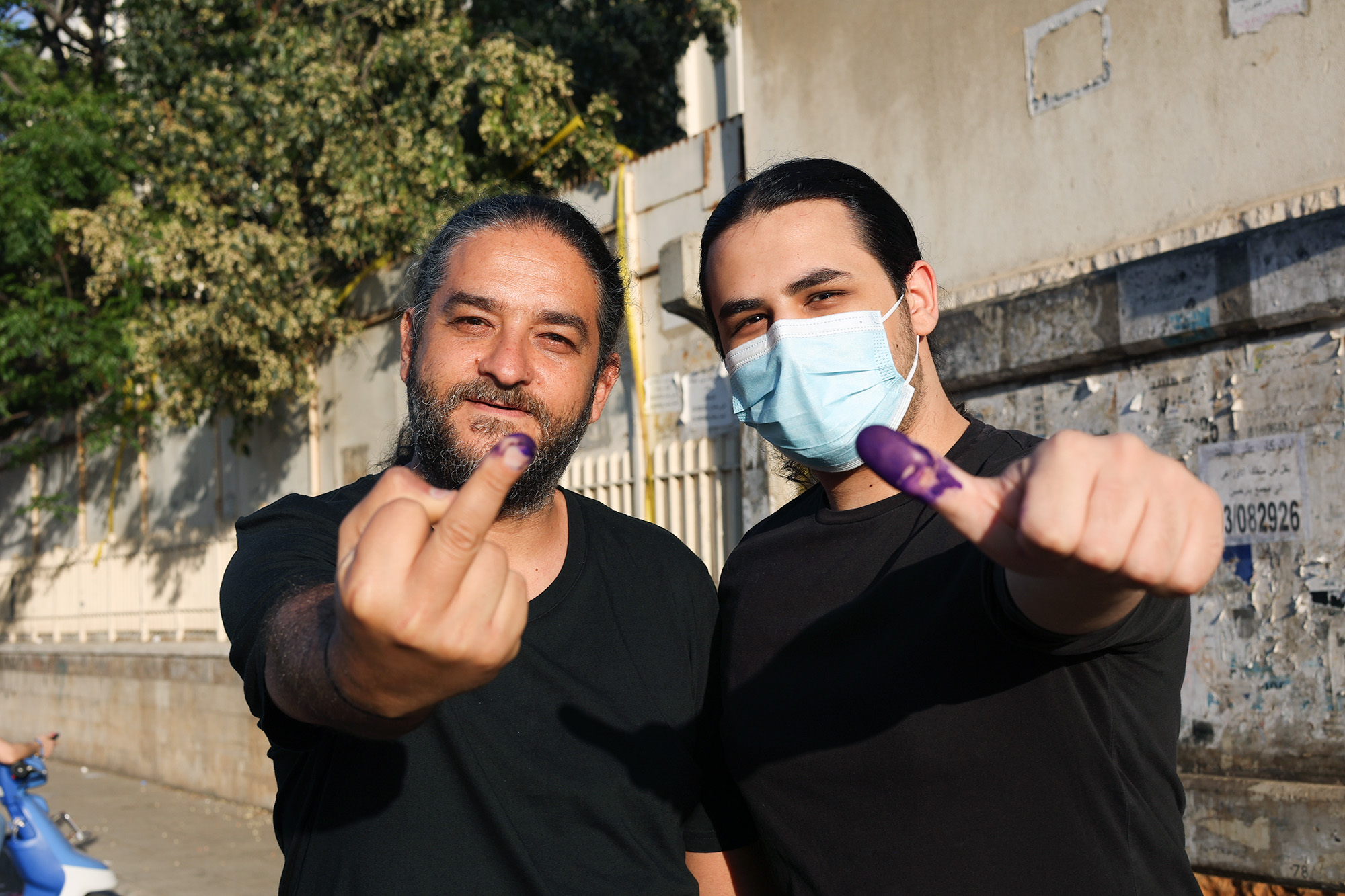Lebanese man, son, purple fingers