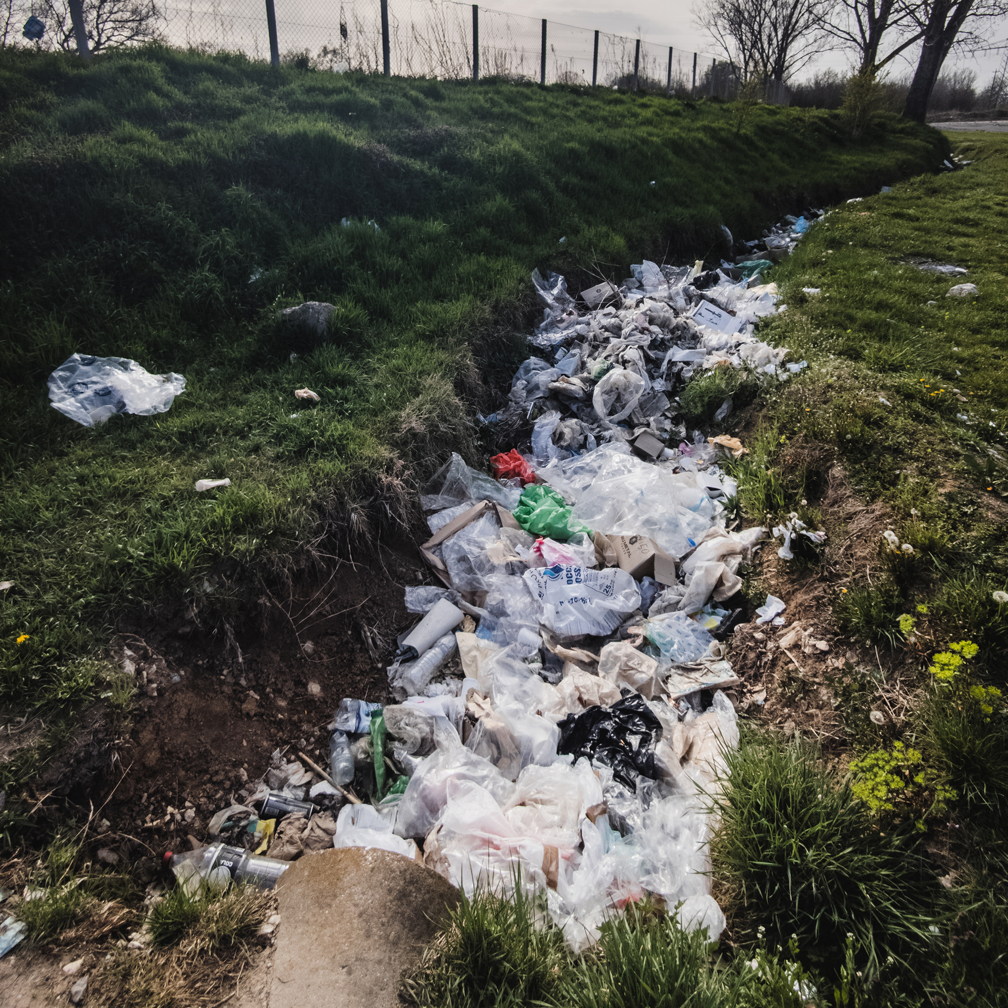 Plastic waste, drainage ditch