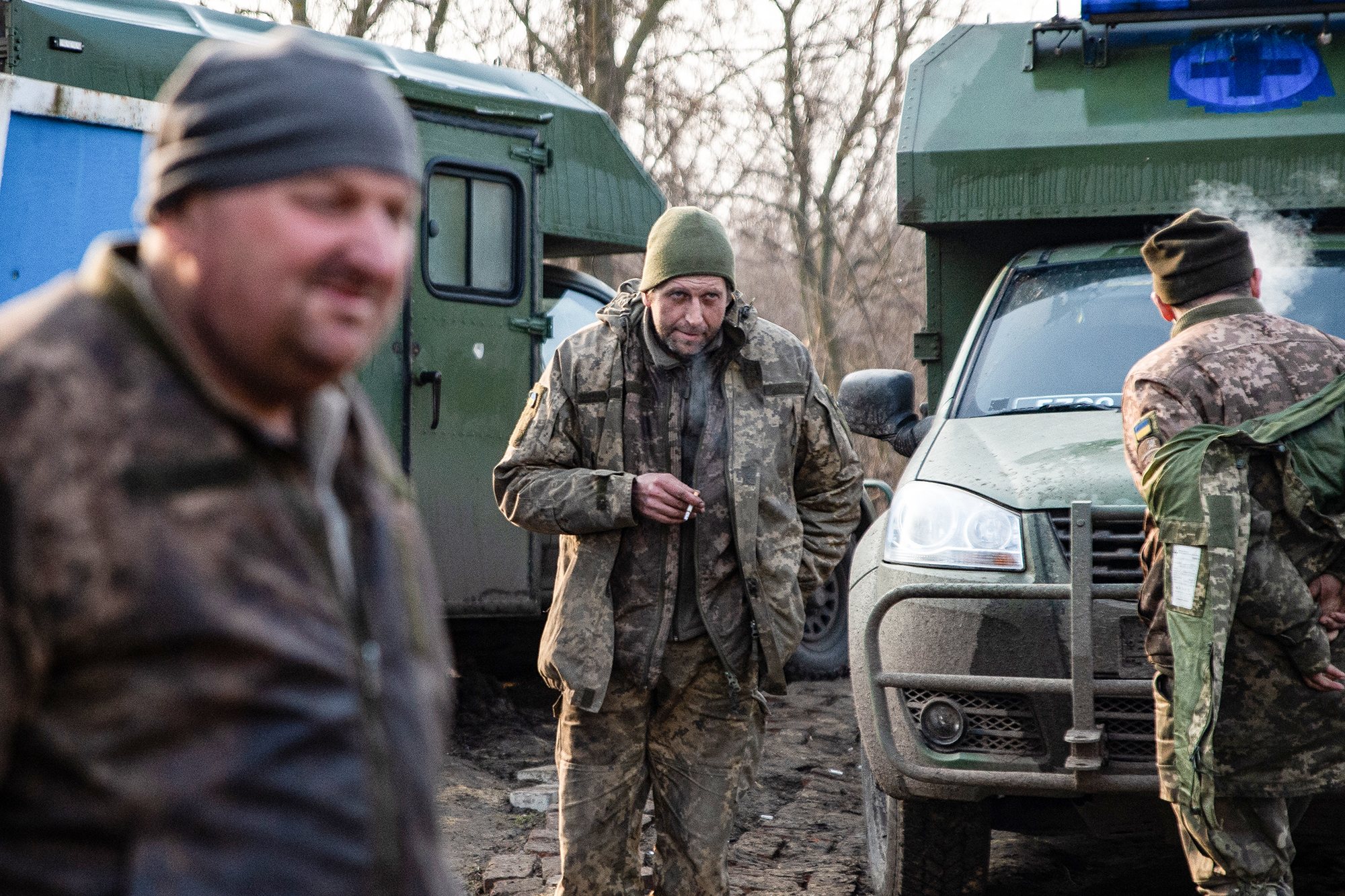 Three Ukrainian soldiers, outside