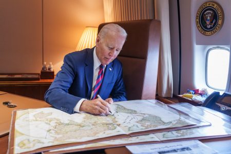 Joe Biden, signs, world map