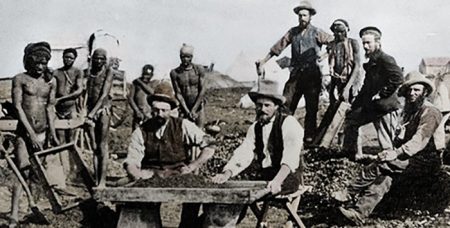 Miners around a diamond sorting table in Kimberley, South Africa, 1800s.