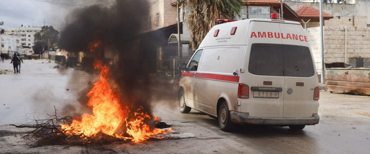 Ambulance, avoids burning debris, Jenin