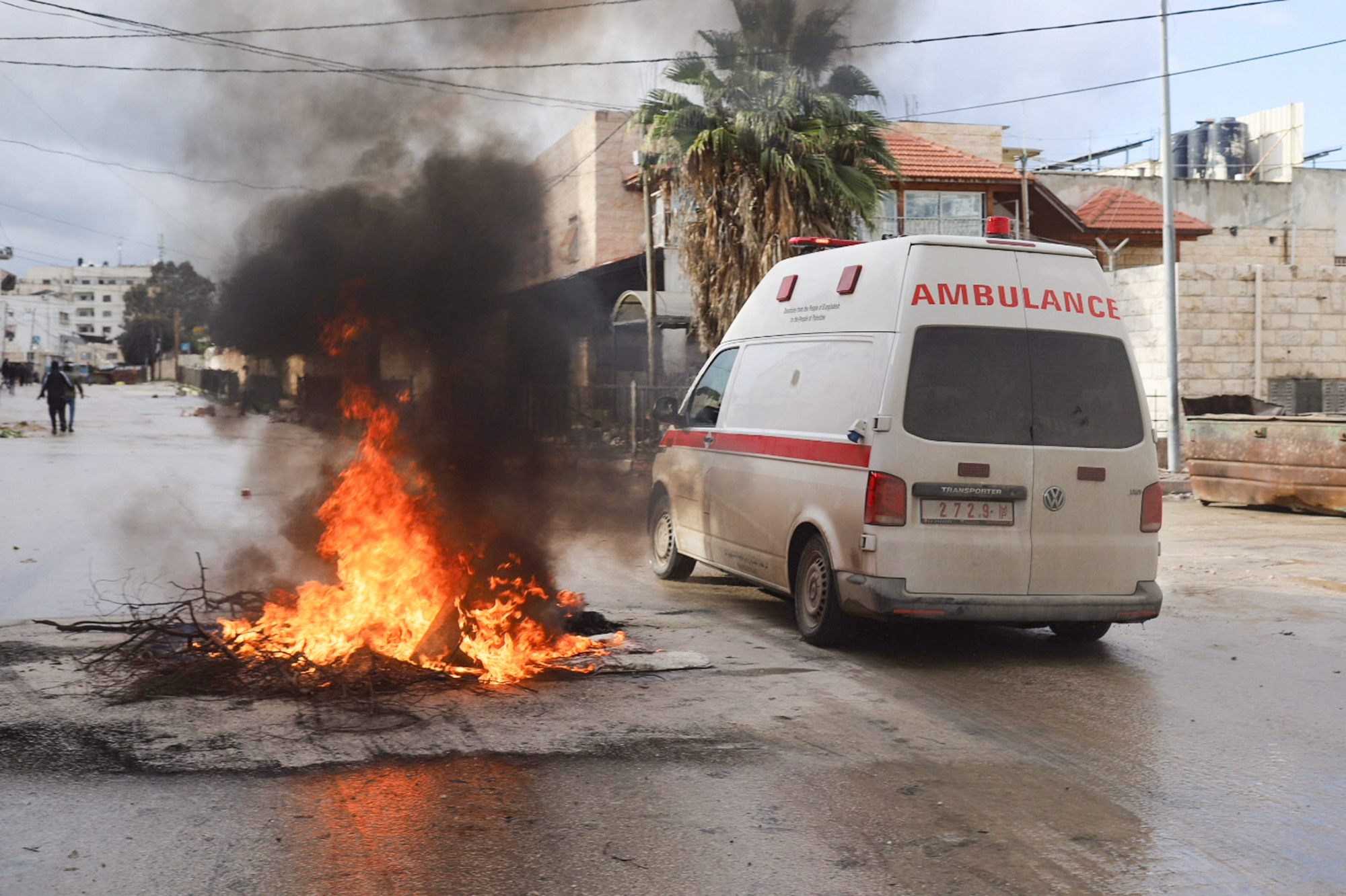 Ambulance, avoids burning debris, Jenin