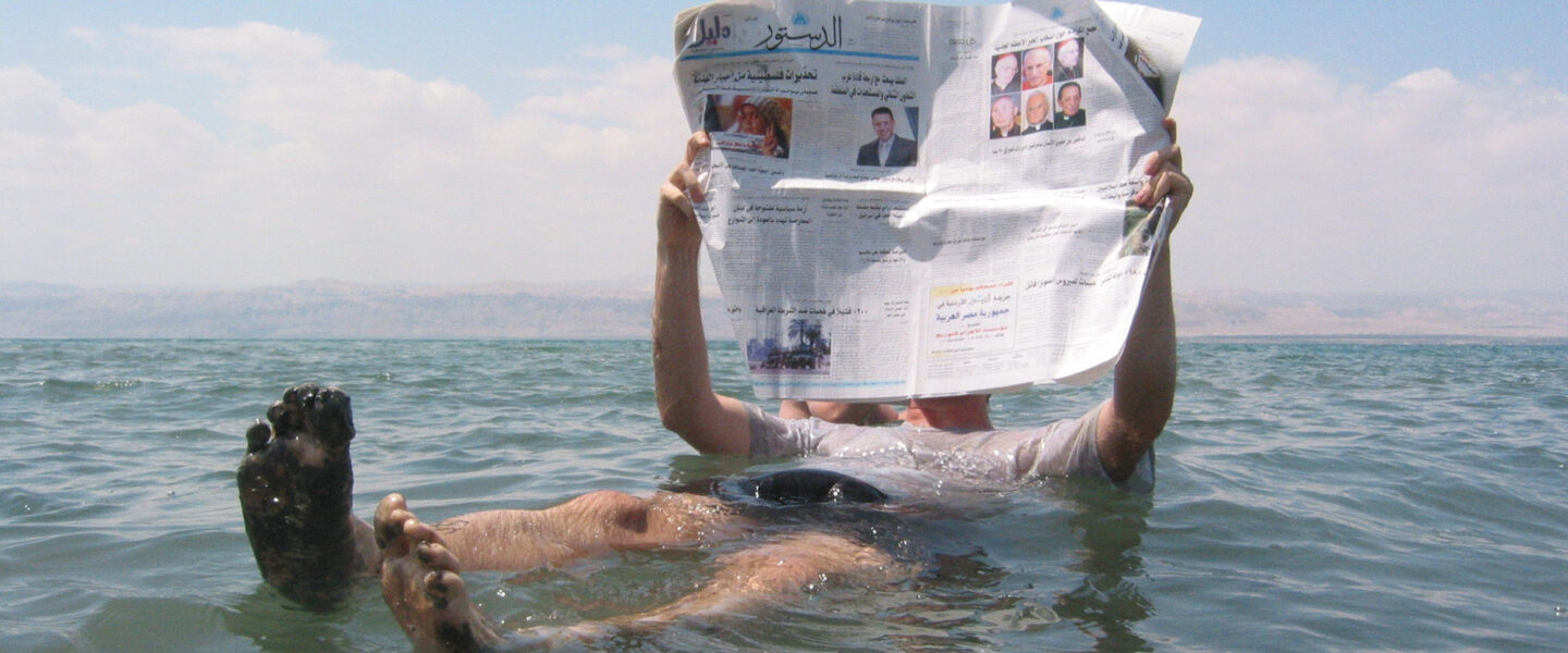 Man reading news,Dead Sea.