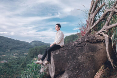 man, alone, sitting on stump