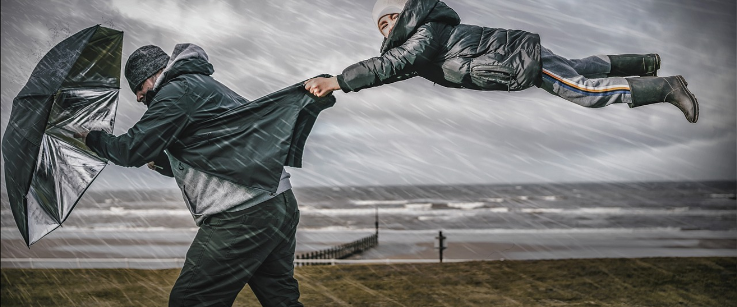 child hanging on, man, windstorm