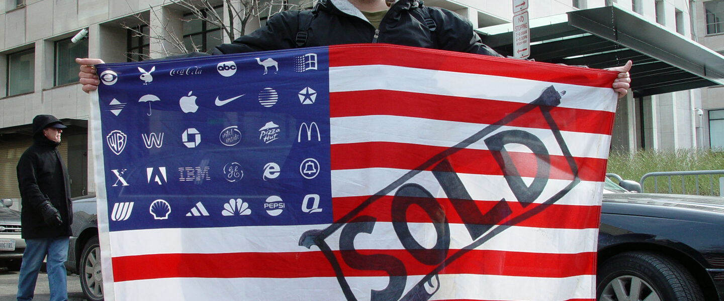 Protester, holding, Adbusters Corporate American Flag