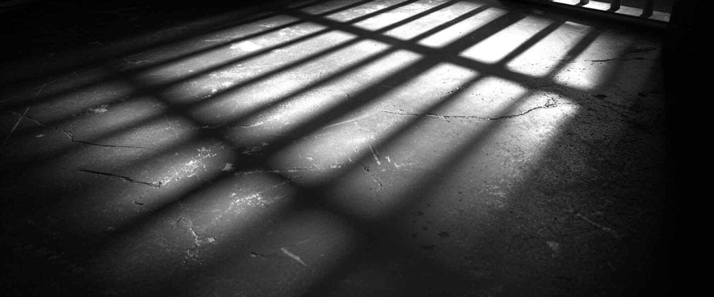 prison bars shadows on the prison cell