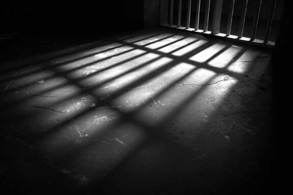 prison bars shadows on the prison cell