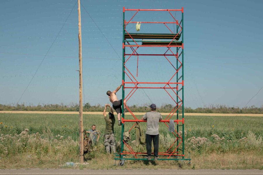Teams, Ukrainian soldiers, installing anti-drone nets.