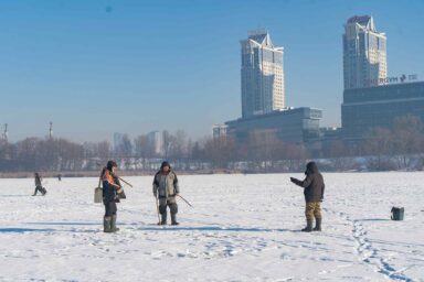 Three ice fishermen, frozen, Dnipro River, Kyiv
