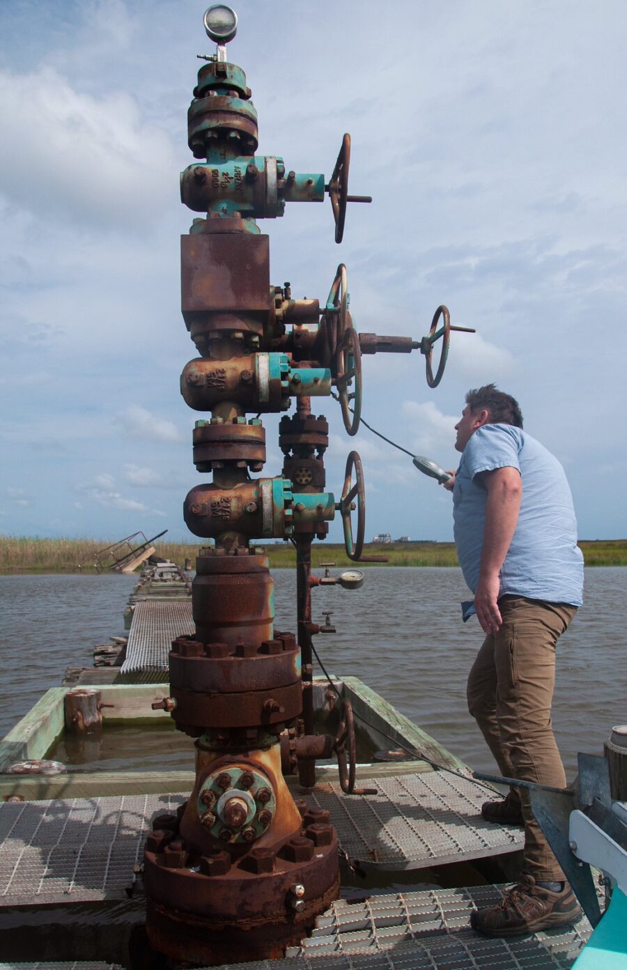 Scott Eustis, inspects, abandoned well